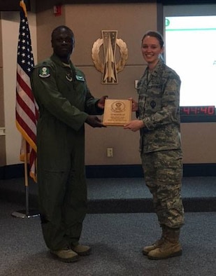 First Lt. Megan Willey, 321st Missile Squadron missile combat crew commander, poses for a picture accepting the Crew of the Quarter award for the 4th quarter, 2016. (U.S. Air Force courtesy photo)