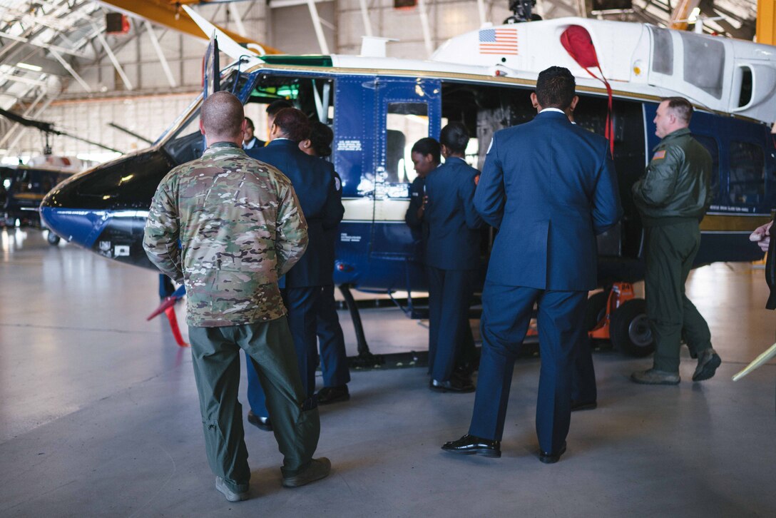 Airmen of the 1st Helicopter Squadron give a tour of a UH-1N Iroquois to a Baltimore Polytechnic Institute High School Air Force Junior Reserve Officer Training Corps cadets at Joint Base Andrews, Md., Feb. 16, 2017. The tour allowed cadets the chance to observe Air Force operations and experience Air Force life. (U.S. Air Force photo by Senior Airman Delano Scott)