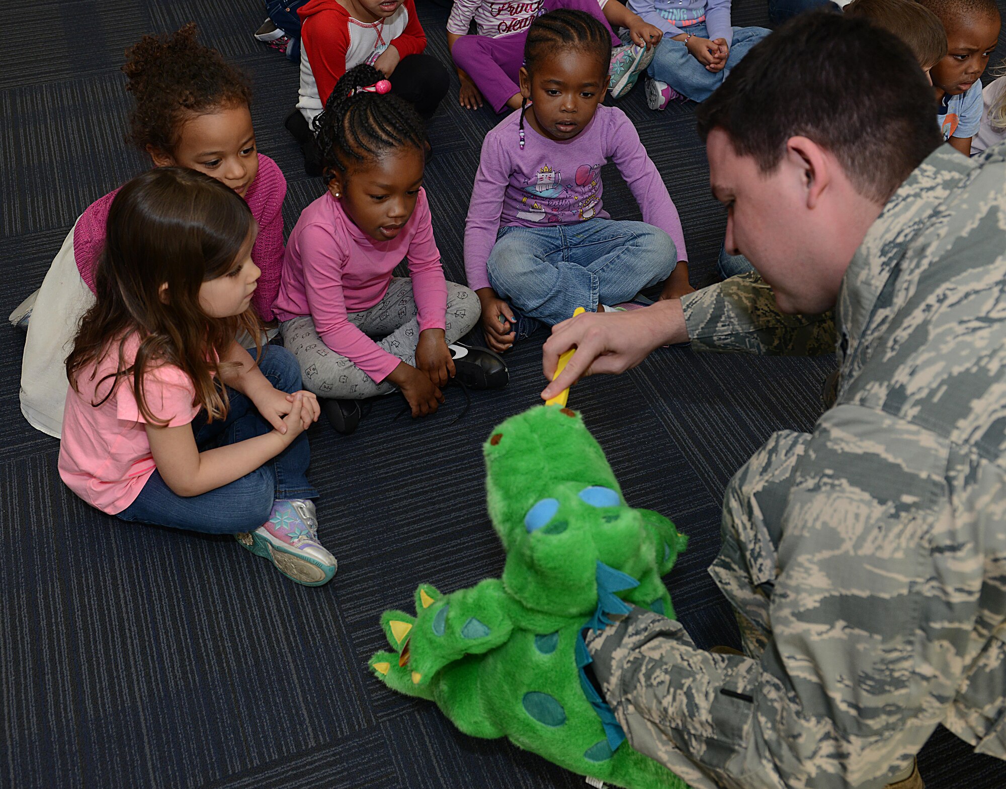 U.S. Air Force Capt. Matthew Rogers, 633rd Dental Squadron dentist, demonstrates reminds children of the importance of cleaning their tongue when they brush their teeth at the Langley Child Development Center at Joint Base Langley-Eustis, Va., Feb. 21, 2017. Dentists reminded children to brush their teeth twice daily, for two minutes each time. (U.S. Air Force photo by Staff Sgt. Teresa J. Cleveland)