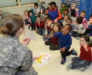 U.S. Army Sgt. Nicole Lewis, U.S. Army Dental Health Activity dental laboratory NCO, asks children to identify healthy food and beverages at the Madison Child Development Center at Joint Base Langley-Eustis, Va., Feb. 17, 2017. February is Children’s Dental Health Month and dental personnel visit the CDCs to teach children about dental hygiene. (U.S. Air Force photo by Staff Sgt. Teresa J. Cleveland)
