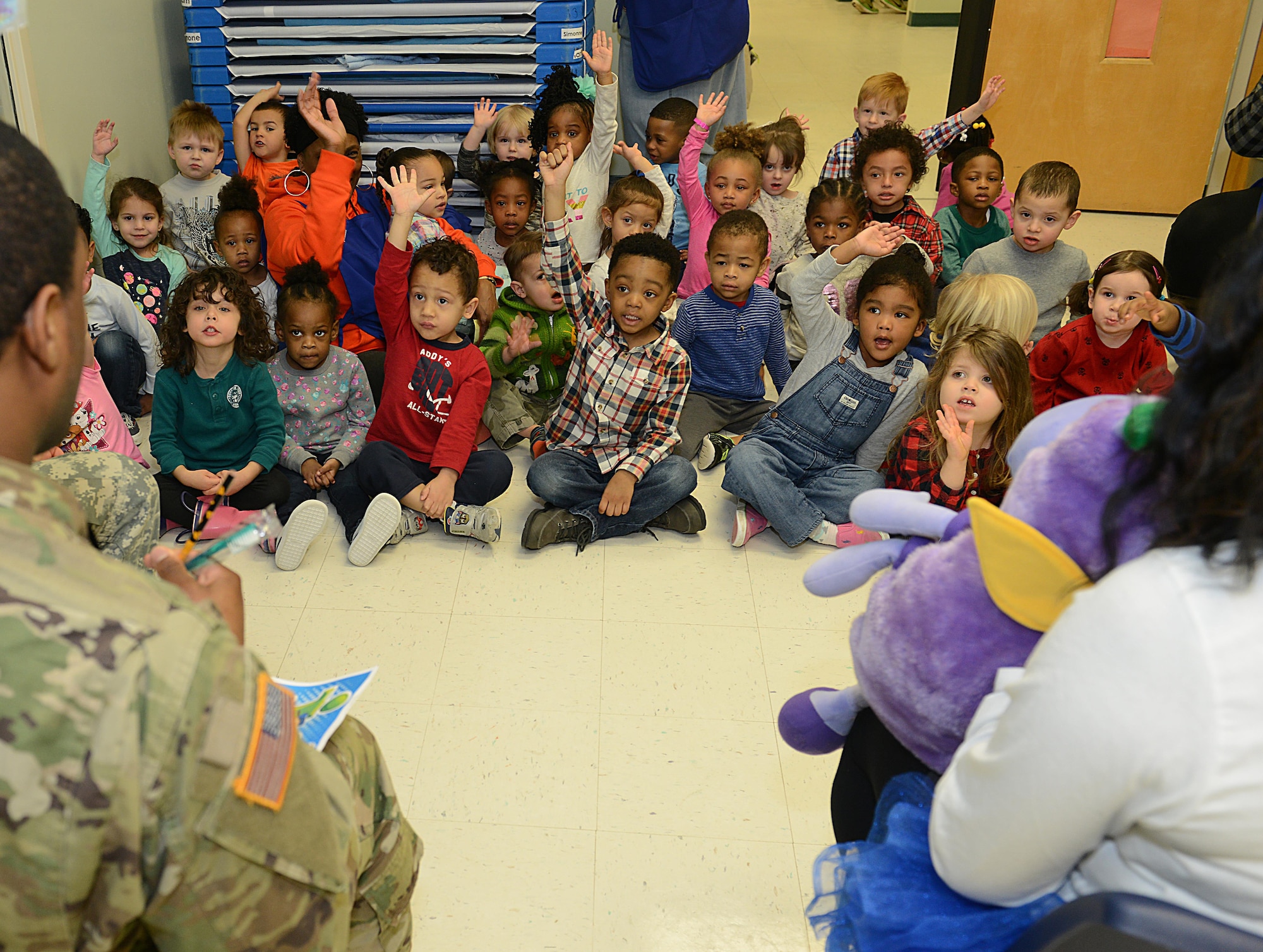 U.S. Army Spc. Aaron Abdullah, U.S. Army Dental Health Activity dental assistant, asks children if they all floss their teeth daily at the Madison Child Development Center at Joint Base Langley-Eustis, Va., Feb. 17, 2017. According to dentists, many young children develop tooth decay due to improper dental hygiene. (U.S. Air Force photo by Staff Sgt. Teresa J. Cleveland)
