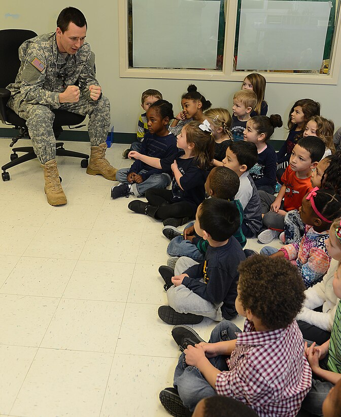 U.S. Army Capt. Tyler Oatmen, U.S. Army Dental Health Activity dentist, discusses dental hygiene with children at the Madison Child Development Center at Joint Base Langley-Eustis, Va., Feb. 17, 2017. During Children’s Dental Health Month, dental technicians teach children the proper way to brush their teeth, how to floss, and to avoid sugary foods and beverages whenever possible. (U.S. Air Force photo by Staff Sgt. Teresa J. Cleveland)