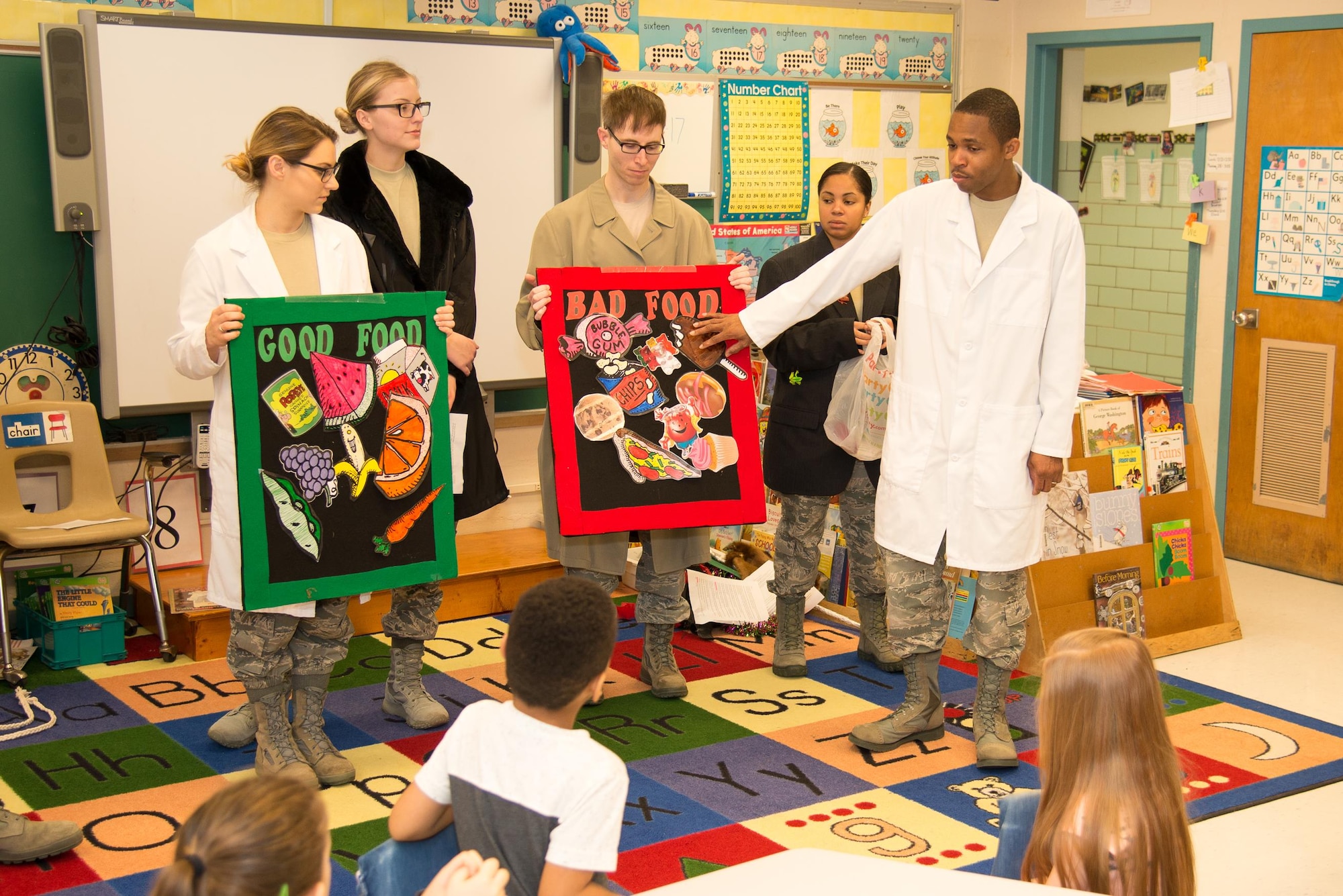 Tech Sgt. Christopher Elam, 436th Aerospace Medicine Squadron NCO in charge of preventative dentistry, discusses foods with high and low sugar content with a kindergarten class Feb. 15, 2017, at Welch Elementary School on Dover Air Force Base, Del. February is National Children’s Dental Health Month. (U.S. Air Force photo by Mauricio Campino)