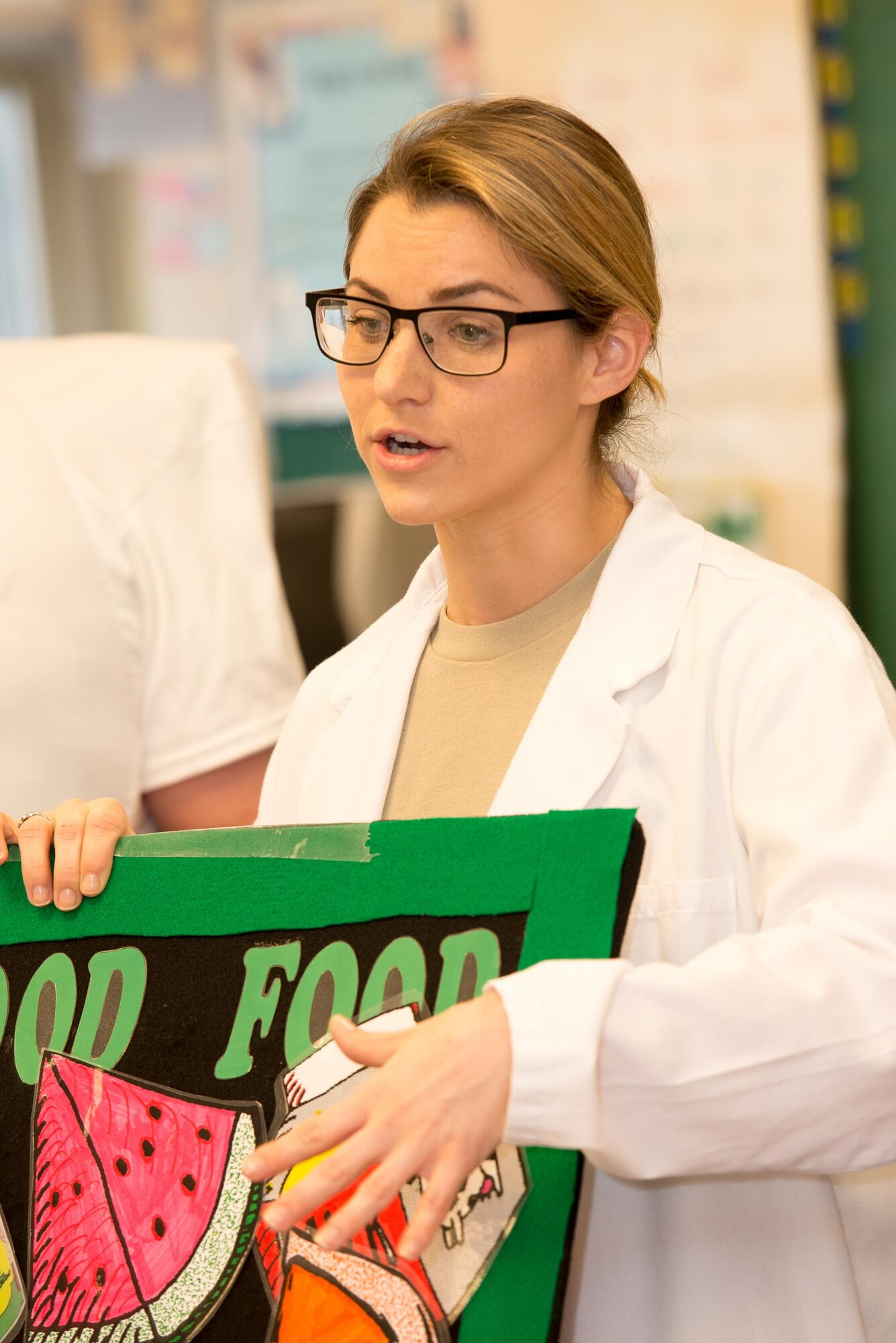 Capt. Marisa Romeo, 436th Aerospace Medicine Squadron general dentist, explains to a kindergarten class why eating foods with low sugar content is so important to preventing cavities Feb. 15, 2017, at Welch Elementary School on Dover Air Force Base, Del. A group of Team Dover Airmen visited the school during National Children’s Dental Health Month to bring awareness and oral health education to the students. (U.S. Air Force photo by Mauricio Campino)