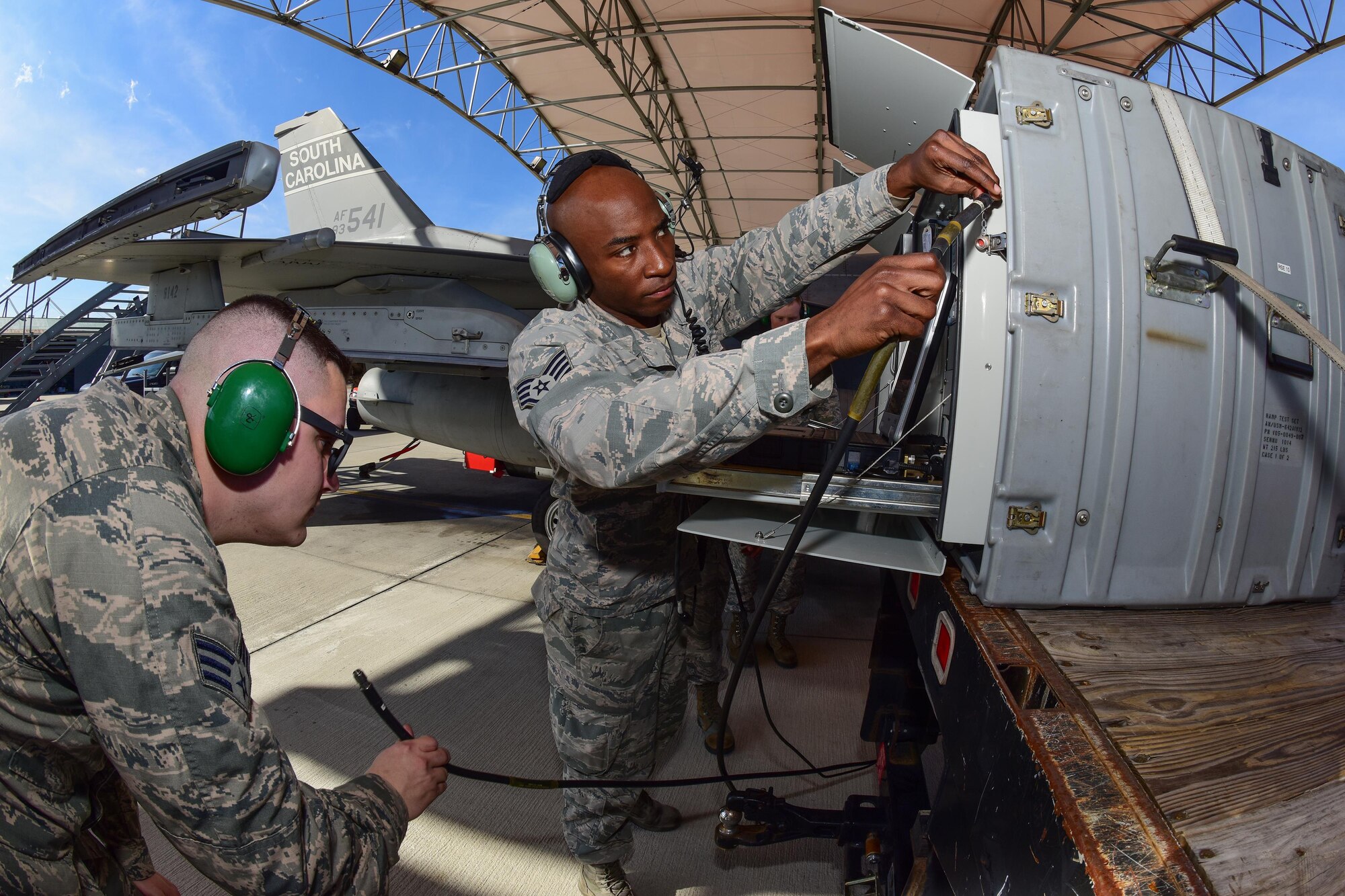 U.S. Air Force Staff Sgt. Timothy Harris-Bey, right, and Senior Airman Brock Latham, both inspectors from the 16th Electronic Warfare Squadron at Eglin Air Force Base, Fla., run tests on one of the South Carolina Air National Guard’s F-16 Fighting Falcons at McEntire Joint National Guard Base, Jan. 18, 2017. The electronic warfare systems used on S.C. Air National Guard F-16 Fighting Falcons underwent an annual Combat Shield inspection; ensuring testing and maintenance requirements are properly conducted. (U.S. Air National Guard photo by Airman 1st Class Megan Floyd)
