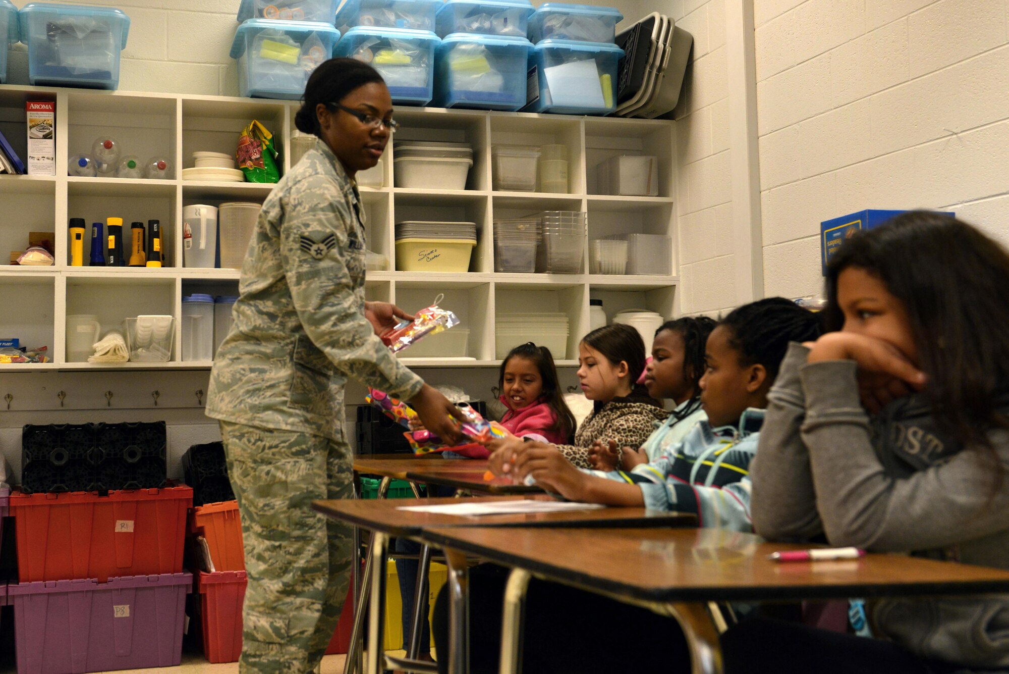 U.S. Air Force Senior Airman Maricia Williams, 20th Dental Squadron oral preventative assistant, passes out dental hygiene tools at Shaw Air Force Base, S.C., Feb. 15, 2017. The dental hygiene tools consisted of items such as a toothbrush, a timer and toothpaste. (U.S. Air Force photo by Airman 1st Class Destinee Sweeney)
