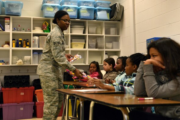 U.S. Air Force Senior Airman Maricia Williams, 20th Dental Squadron oral preventative assistant, passes out dental hygiene tools at Shaw Air Force Base, S.C., Feb. 15, 2017. The dental hygiene tools consisted of items such as a toothbrush, a timer and toothpaste. (U.S. Air Force photo by Airman 1st Class Destinee Sweeney)