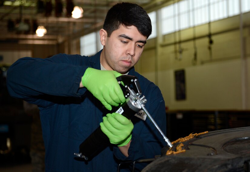 U.S. Air Force Airman 1st Class Justin West, 733rd Logistics Readiness Squadron vehicle maintainer, coats the fifth wheel of a tractor trailer with a bio-based grease at Joint Base Langley-Eustis, Va., Jan. 31, 2017. JBLE has partnered with the Defense Logistics Agency to host a 12-month long experiment that will perform a test of the bio-based grease on three vehicles from different mission assets across the installation. (U.S. Air Force photo by Airman 1st Class Kaylee Dubois)