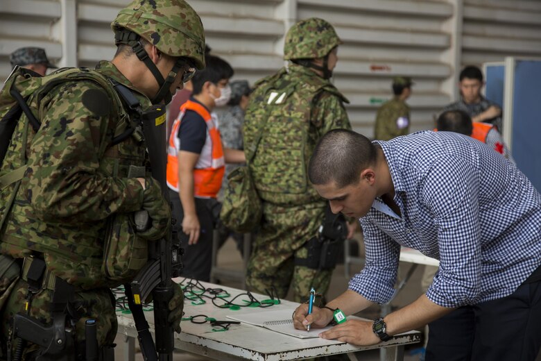 A Japan Air Self-Defense Force member helps process a role player during a noncombatant evacuation operation, as part of Cobra Gold 17 at Naval Airbase Utapao, Thailand, Feb. 19, 2017. The drill was conducted to exercise joint, multinational cooperation during disaster relief. Cobra Gold is the largest Theater Security Cooperation exercise in the Indo-Asia-Pacific region and is an integral part of the U.S. commitment to strengthen engagement in the region. U.S., Thai, Malaysian and Japanese forces participated in the disaster relief drill.