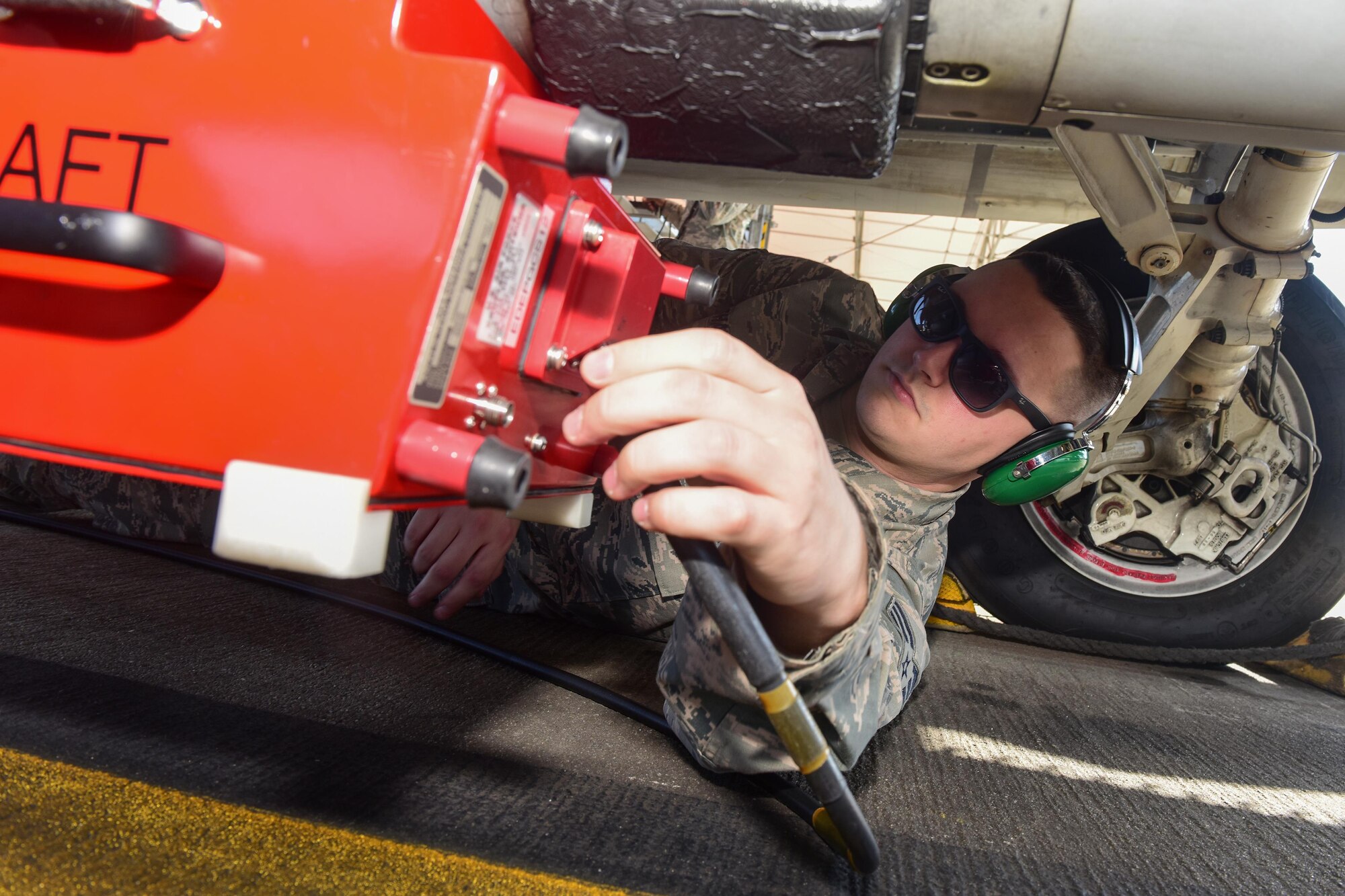 U.S. Air Force Senior Airman Brock Latham, inspector from the 16th Electronic Warfare Squadron at Eglin Air Force Base, Fla., removes a testing device from one of the South Carolina Air National Guard’s F-16 Fighting Falcons at McEntire Joint National Guard Base, Jan. 18, 2017. The electronic warfare systems used on S.C. Air National Guard F-16 Fighting Falcons underwent an annual Combat Shield inspection; ensuring testing and maintenance requirements are properly conducted.   (U.S. Air National Guard photo by Airman 1st Class Megan Floyd)