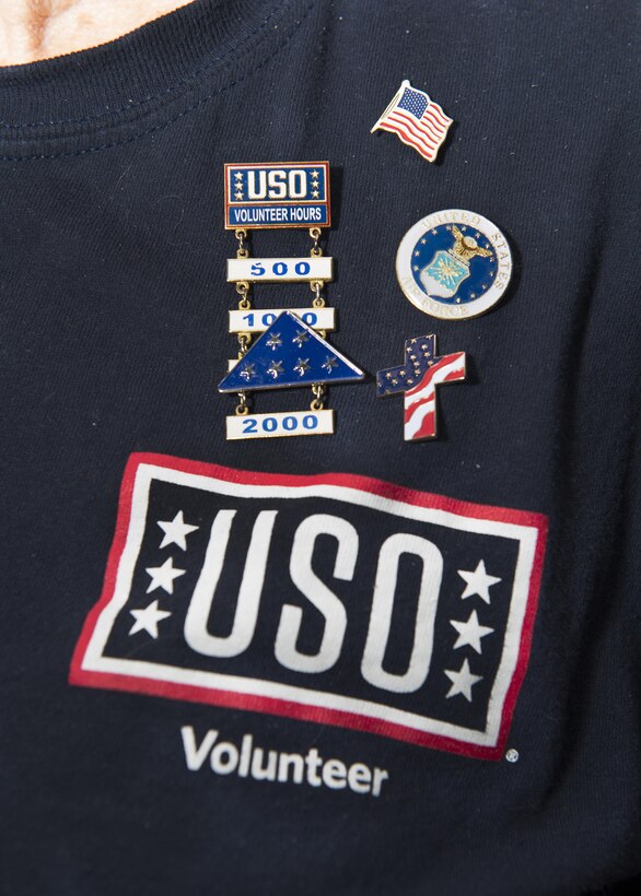 Josie Donithan, USO Delaware volunteer, wears pins she’s received from volunteering with the USO Feb. 21, 2017, at Dover Air Force Base, Del. Donithan has volunteered more than 3,600 hours with the USO and earned flair to show her dedication to the service members. (U.S. Air Force photo by Senior Airman Zachary Cacicia)