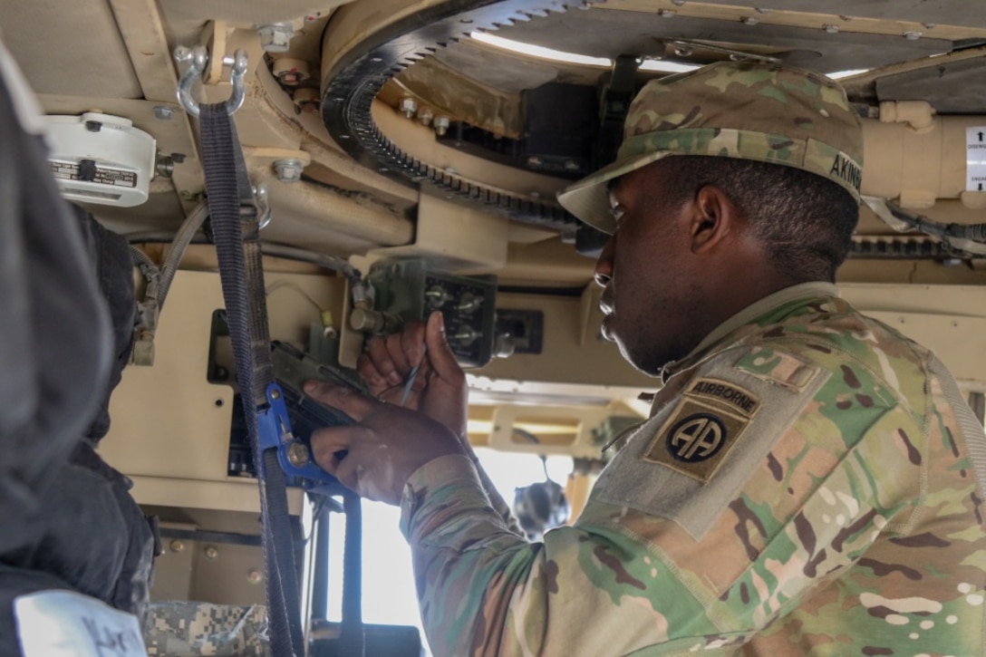 Army Pfc. Oluwemimo Alenbayo, a signal support systems specialist attached to 1st Squadron, 73rd Cavalry Regiment, 2nd Brigade Combat Team, 82nd Airborne Division, fills an Advanced System Improvement Program tactical radio in a vehicle at Qayyarah West Airfield, Iraq, Feb. 9, 2017. The brigade conducted a communications exercise in preparation for the upcoming Iraqi security forces offensive into West Mosul. Army photo by Staff Sgt. Jason Hull