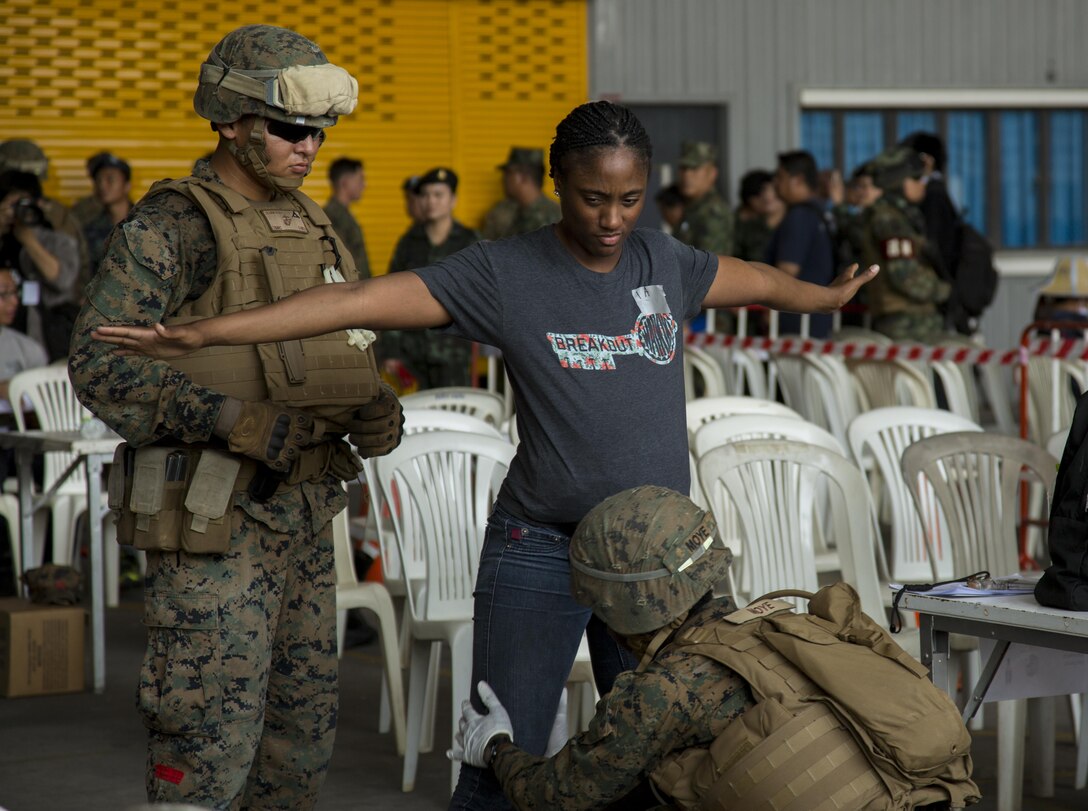 U.S. Marines pat down a role player for contraband during a noncombatant evacuation operation, as part of Cobra Gold 17 at Naval Airbase Utapao, Thailand, Feb. 19, 2017. The drill was conducted to exercise joint, multinational cooperation during disaster relief. Cobra Gold is the largest Theater Security Cooperation exercise in the Indo-Asia-Pacific region and is an integral part of the U.S. commitment to strengthen engagement in the region. U.S., Thai, Malaysian and Japanese forces participated in the disaster relief drill. 