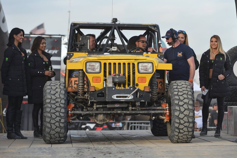Gunnery Sgt. Adam Arsenault, a mission planning instructor at Expeditionary Warfare Training Group Pacific, currently stationed at Naval Air Station Coronado, and Marine Corps CWO 3 Spencer Morris, a counter intelligence officer, currently stationed at the Pentagon, drive car 4503 across the stage after the King of the Hammers race in Johnson Valley, Calif., Feb. 9, 2017. Arsenault and Morris placed sixth in their class. (Courtesy photo)