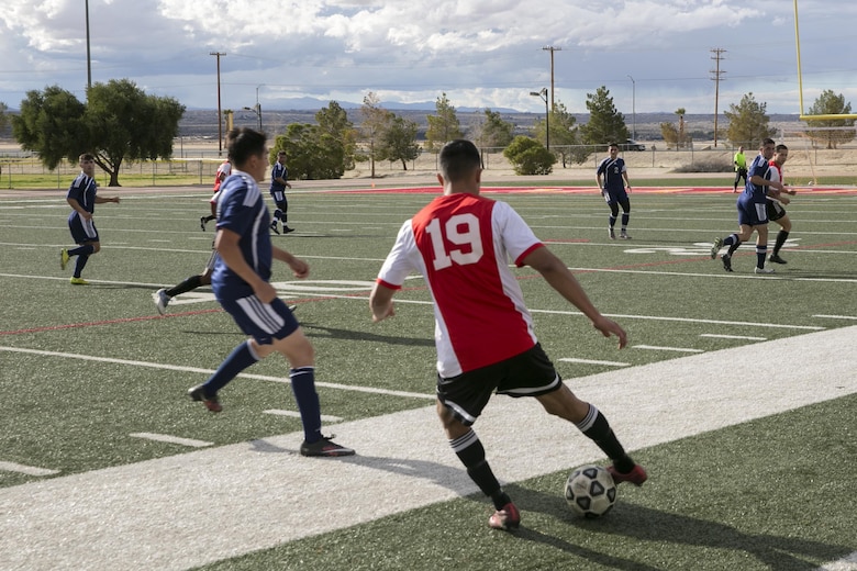A player with Pendleton Futbol Club dribbles during a pre-season game of 29 Palms FC versus Pendleton FC at Felix Field aboard Marine Corps Air Ground Combat Center, Twentynine Palms, Calif., Feb. 11, 2017. 29 Palms FC is preparing for a tournament at Fort Irwin National Training Center in April. (U.S. Marine Corps photo by Lance Cpl. Dave Flores)