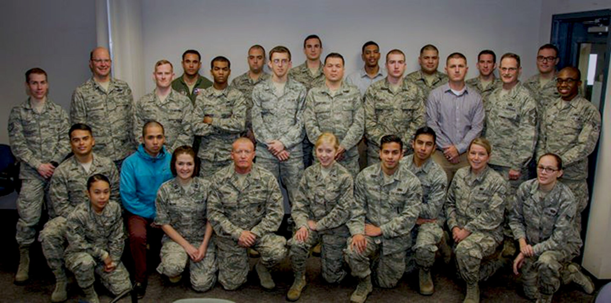 Col. Raymond Kozak, 349th Air Mobility Wing commander, and Chief Master Sgt. Bryan A. Payne, 349th AMW command chief master sergeant, pose for a photo with the wing's newest Citizen Airmen during newcomers orientation Feb. 11, 2017, at Travis Air Force Base, Calif. The 349th AMW provides mission-ready, fully integrated, citizen airmen for operational capability and surge capacity in rapid global mobility.