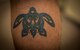 U.S. Air Force Staff Sgt. Aaron Peacock, a 35th Maintenance Squadron aerospace propulsion craftsman, displays his tattoo at Misawa Air Base, Japan, Feb. 15, 2017. Peacock’s tattoo is identical to the one his father has and their military connection. (U.S. Air Force photo by Tech. Sgt. Araceli Alarcon)
