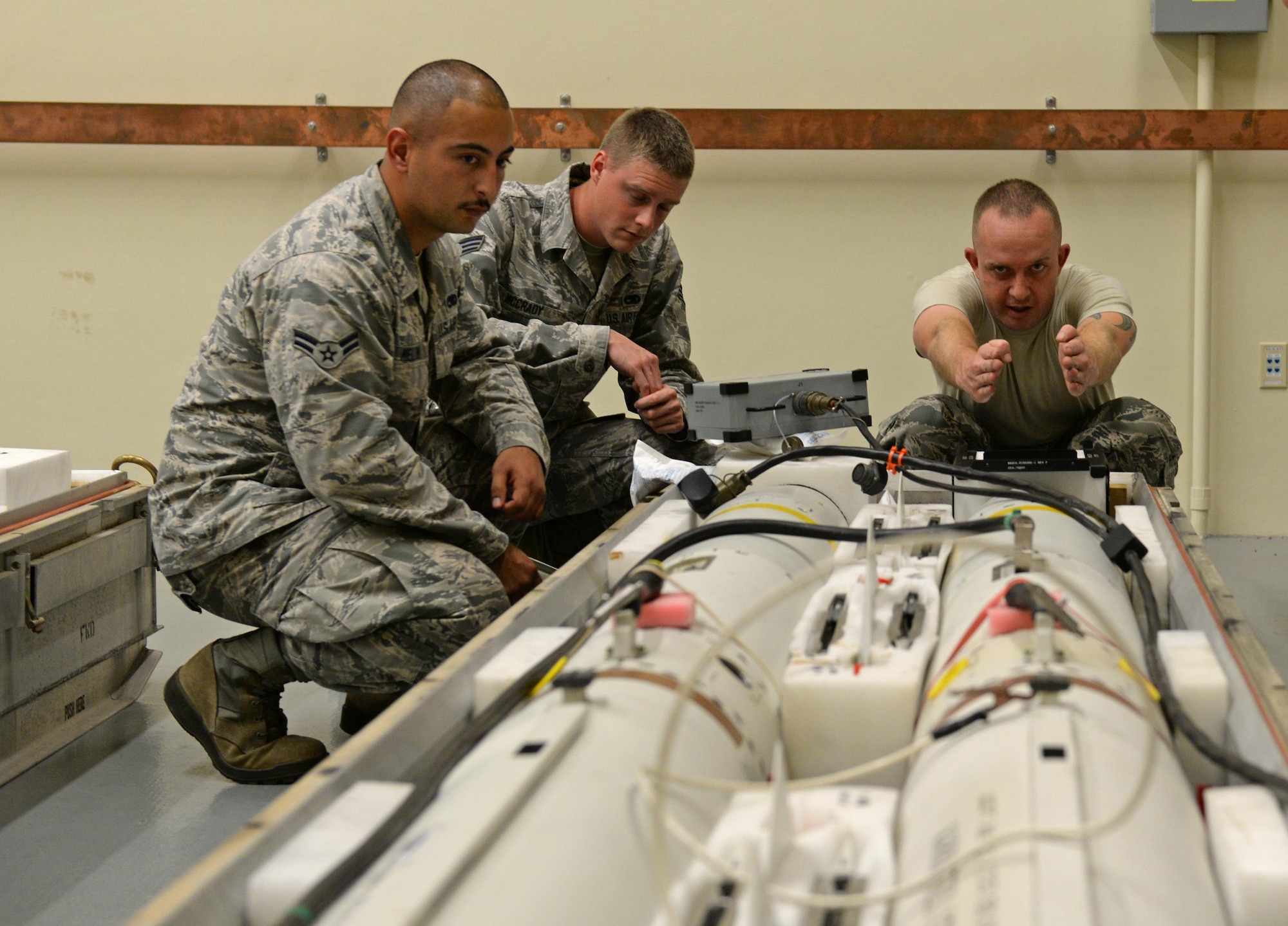 From left, U.S. Air Force Airman 1st Class Richard Melton, Senior Airman Rand McCrady and Staff Sgt. Jeffrey Davies, assigned to the 36th Munitions Squadron, inspect an AGM-88 high-speed anti-radiation missile (HARM) Jan. 26, 2017, at Andersen Air Force Base, Guam. The 36th MUNS recently opened their new precision-guided munitions shop in early January 2017, where Airmen test, inspect and update missiles. (U.S. Air Force photo by Senior Airman Alexa Ann Henderson)