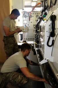 Salvage diver Spc. Nathaniel Marquez (back) and Sgt. Christopher Miller, both with 511th Engineer Dive Detachment out of Fort Eustis, Va., do maintenance checks on a Standard Navy Double Lock Recompression Chamber System, at Kuwait Naval Base, Kuwait, Feb. 02, 2017. The maintenance check is in preparation of training soldiers in operation of the chamber, Soldier advancement and to help a soldier with an injury sustained during a previous training exercise.