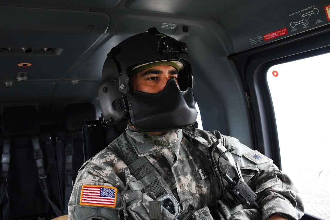 Army National Guard Sgt. 1st Class Marty Ortiz flies inside a UH-72 Lakota helicopter and prepares to take video assessing flood damage in potentially vulnerable areas in Merced County, Merced, Calif., Feb. 19, 2017. Ortiz is assigned to the California Army National Guard’s 1st Battalion, 140th Air Assault Regiment. Air National Guard photo by Senior Airman Daniel Crosier