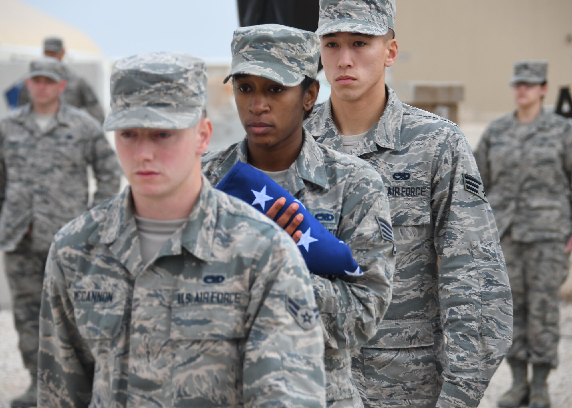 An Al Udeid Air Base Honor Guard team folds the U.S. flag during a Presidents Day retreat ceremony at Al Udeid AB, Qatar, Feb. 20, 2017. The ceremony honored the lives and contributions of the Presidents of the United States, both past and present. (U.S. Air Force photo by Senior Airman Miles Wilson)