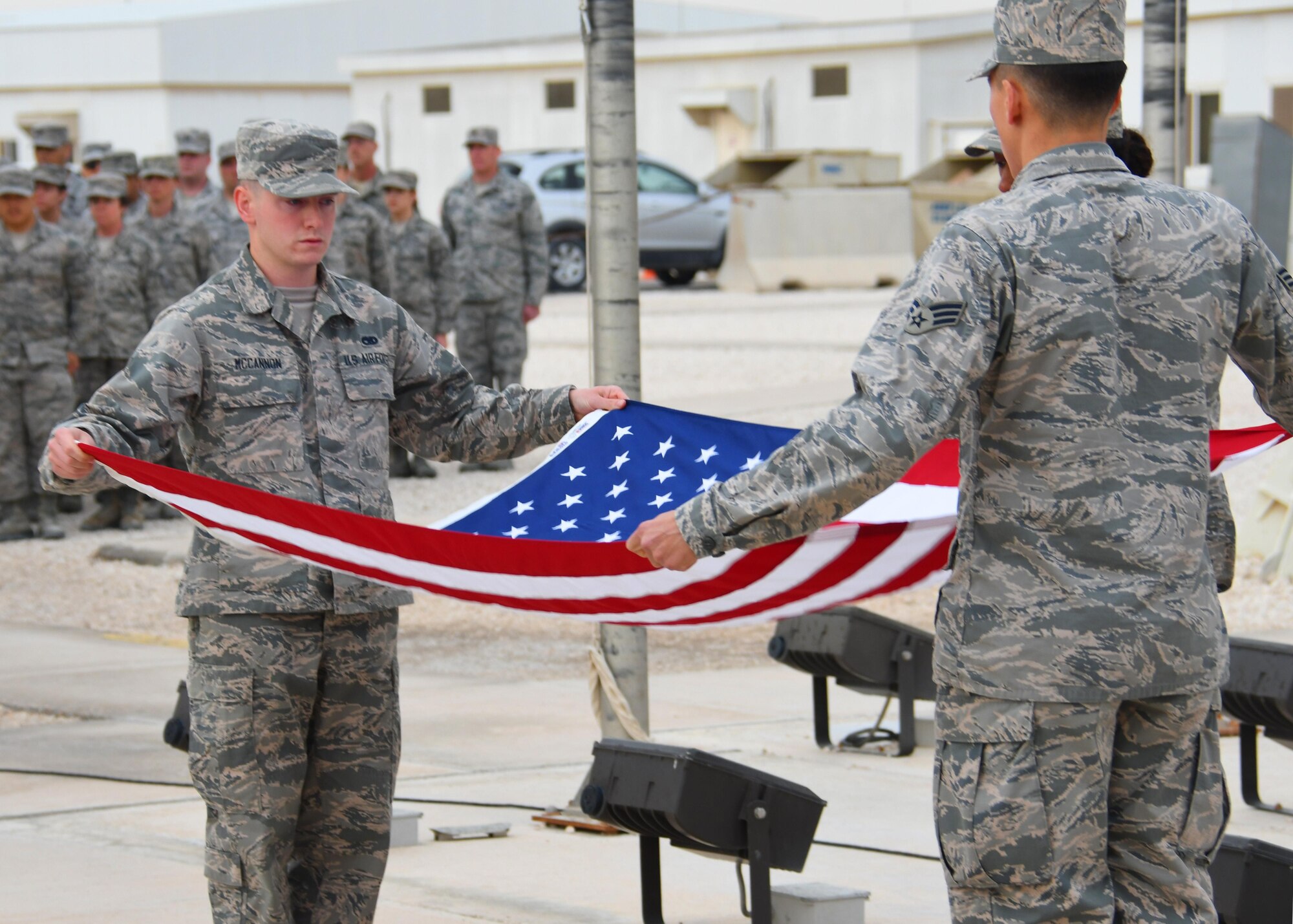 An Al Udeid Air Base Honor Guard team folds the U.S. flag during a Presidents Day retreat ceremony at Al Udeid AB, Qatar, Feb. 20, 2017. The ceremony honored the lives and contributions of the Presidents of the United States, both past and present. (U.S. Air Force photo by Senior Airman Miles Wilson)