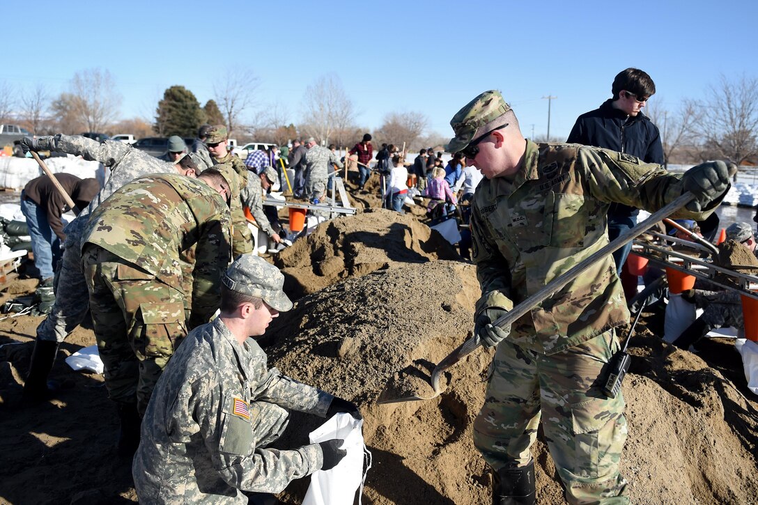 Army National Guard soldiers and volunteers fill sandbags to reinforce berms along the Bighorn River in Worland, Wyo., Feb. 12, 2017. Army National Guard photo by Sgt. 1st Class Jimmy McGuire