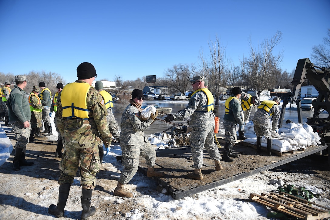 Army National Guard soldiers load sandbags onto pallets to reinforce berms along the Bighorn River in Worland, Wyo., Feb. 13, 2017. Army National Guard photo by Sgt. 1st Class Jimmy McGuire