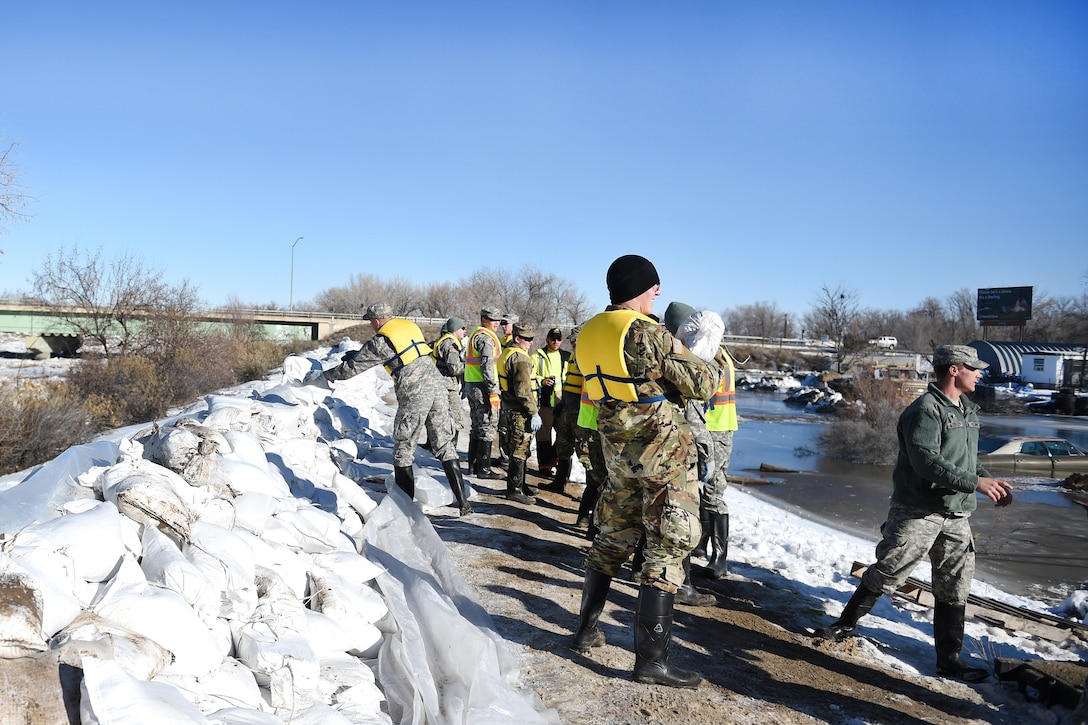 Army National Guard soldiers stack sandbags to reinforce berms along the Bighorn River in Worland, Wyo., Feb. 13, 2017. Army National Guard photo by Sgt. 1st Class Jimmy McGuire