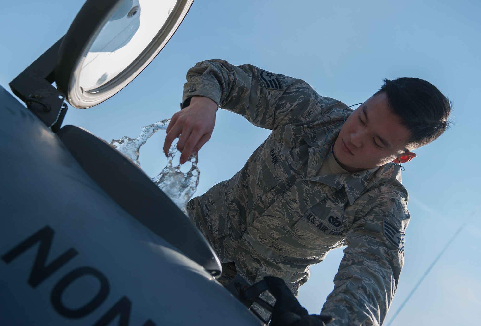 Staff Sgt. Ju Ho Park, 1st Combat Communications Squadron electrical power production craftsman, pulls ice out of a water tank during a training exercise on Ramstein Air Base, Germany, Feb. 16, 2017. Airmen from 1 CBCS use mock-deployment exercises to enhance job skills and maintain equipment to be prepared for deployments at any given time. (U.S. Air Force photo by Senior Airman Lane T. Plummer)
