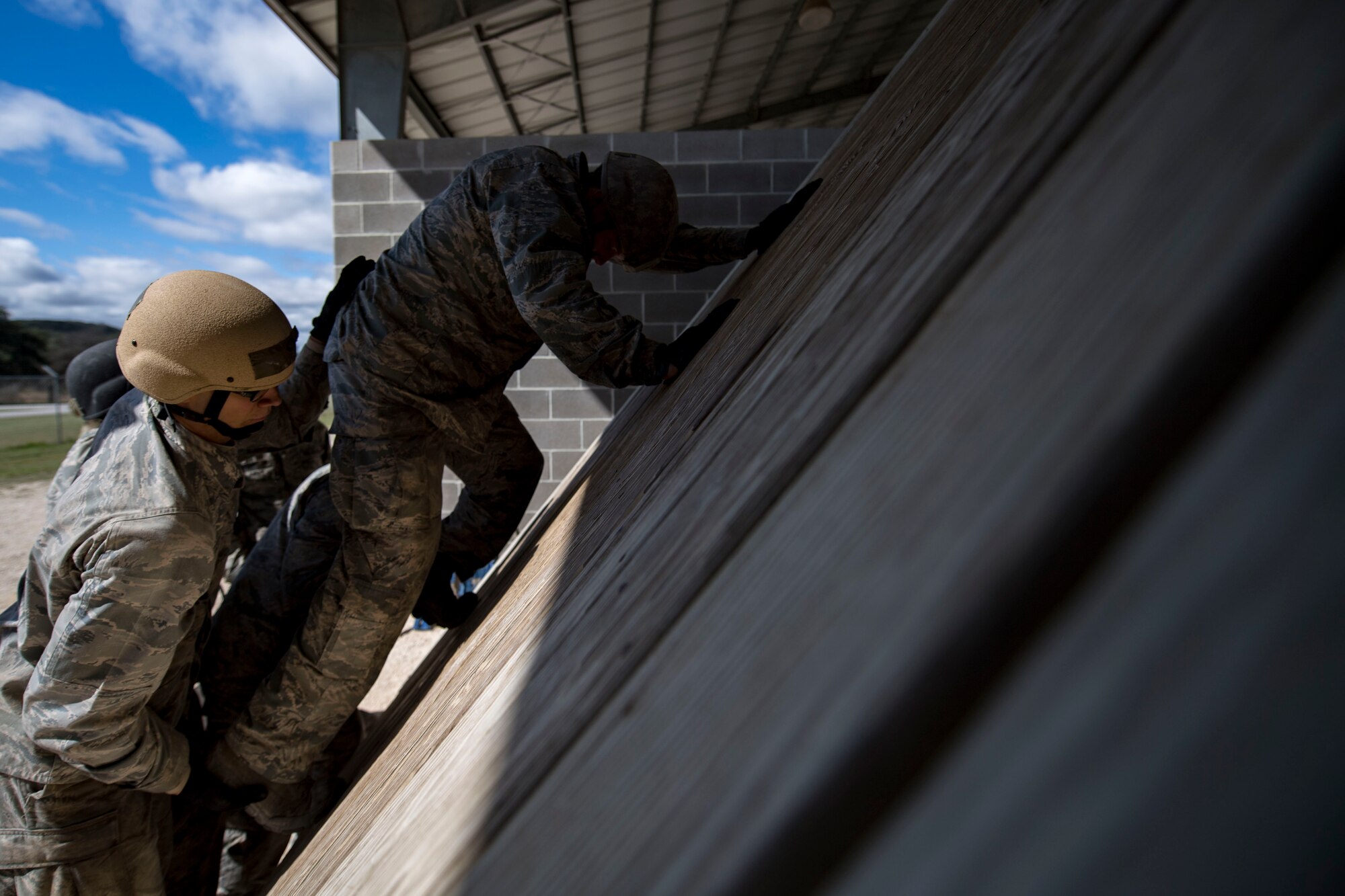 Air Force Academy cadets work to complete a tasked obstacle training during an Air Liaison Officer Aptitude Assessment, Feb. 14, 2017, at Camp Bullis, Texas. The cadets were forced to use critical thinking skills to complete tasked obstacles as a team. (U.S. Air Force photo by Airman 1st Class Daniel Snider)