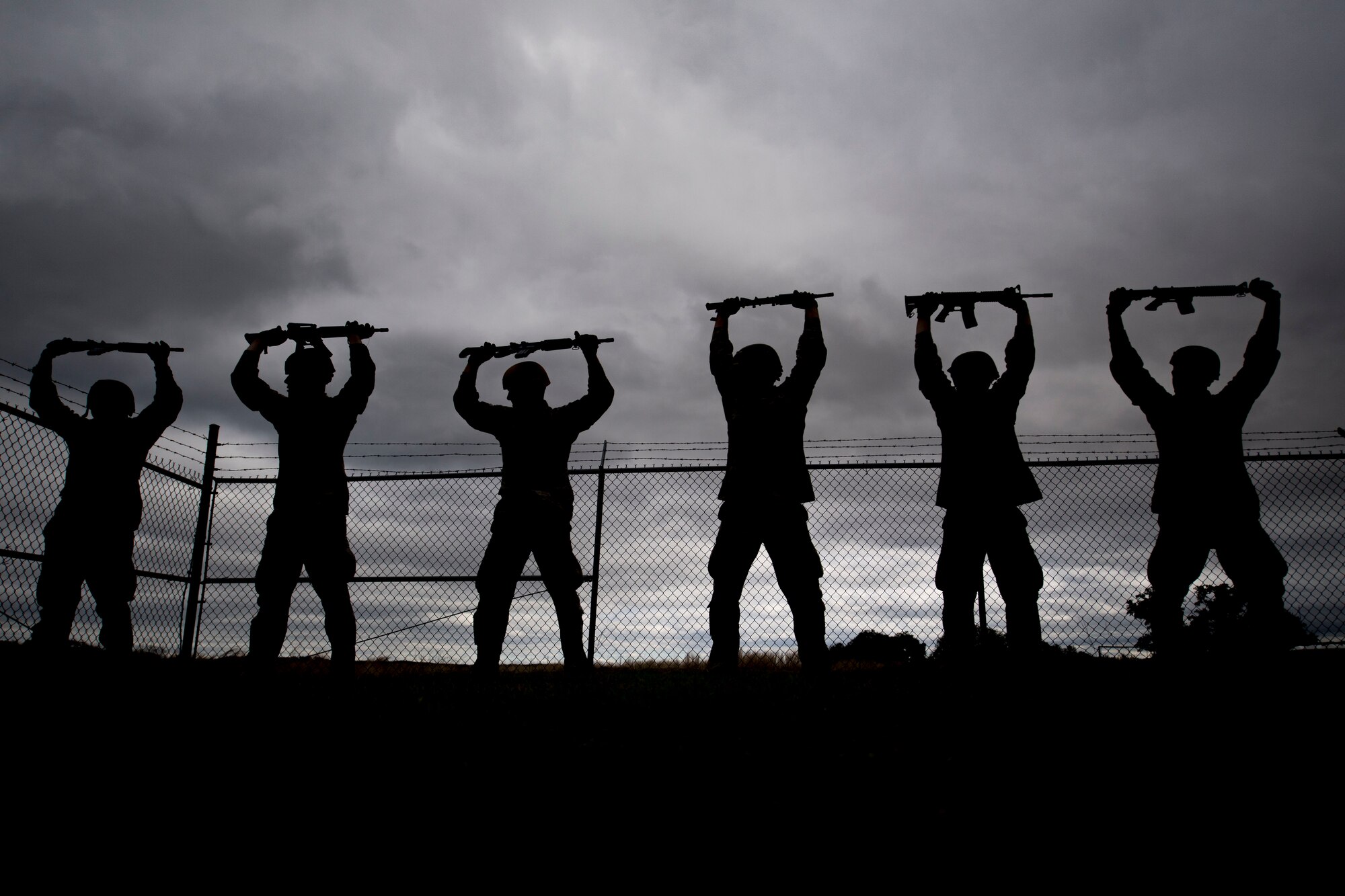 Air Force Academy cadets hold a training rifle above their head during tasked obstacle training at an Air Liaison Officer Aptitude assessment, Feb. 14, 2016, at Camp Bullis, Texas. The cadets were divided into two groups for the tasked obstacle portion of the assessment, leaving the other group time to work out. (U.S. Air Force photo by Airman 1st Class Daniel Snider)