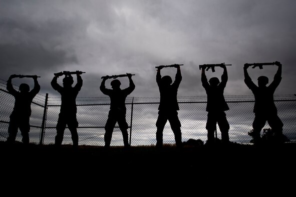 Air Force Academy cadets hold a training rifle above their head during tasked obstacle training at an Air Liaison Officer Aptitude assessment, Feb. 14, 2016, at Camp Bullis, Texas. The cadets were divided into two groups for the tasked obstacle portion of the assessment, leaving the other group time to work out. (U.S. Air Force photo by Airman 1st Class Daniel Snider)