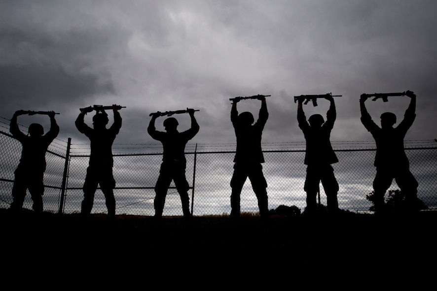 Air Force Academy cadets hold a training rifle above their head during tasked obstacle training at an Air Liaison Officer Aptitude assessment, Feb. 14, 2016, at Camp Bullis, Texas. The cadets were divided into two groups for the tasked obstacle portion of the assessment, leaving the other group time to work out. (U.S. Air Force photo by Airman 1st Class Daniel Snider)