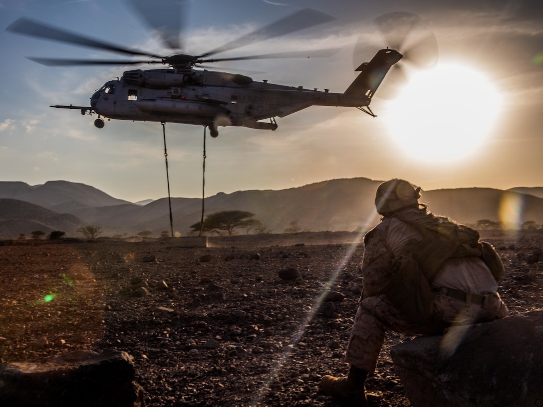 U.S. Marine Cpl. Christopher Russell, a landing support specialist, watches as a CH-53E Super Stallion lifts a concrete barrier during helicopter external load training at Arta Beach, Djibouti, Feb. 16, 2017. A CH-53E has the capability to lift up to 36,000 pounds and can lift most military vehicles ranging from a high mobility, multi-purpose, wheeled vehicle to a light armored vehicle. The Marines and Sailors of the 11th Marine Expeditionary Unit consistently train to keep their skills ready for crisis response and contingency operations throughout the Central Command area of responsibility. The Marines are with Combat Logistics Battalion 11 and the Stallion and crew are with Marine Medium Tiltrotor Squadron 163, 11th MEU.