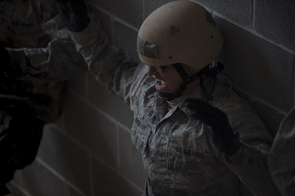 U.S. Air Force Academy Cadet Darnell Jones performs a wall sit during the Air Liaison Officer Aptitude Assessment, Feb. 14, at Camp Bullis, Texas. The cadets were divided into two groups for the tasked obstacle portion of the assessment, leaving the other group time to workout. (U.S. Air Force photo by Tech. Sgt. Zachary Wolf)