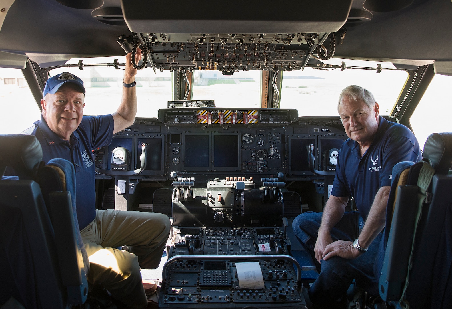 Charlie Adcock (right), Family Motor Coach Association president, and Jon Walker FMCA senior vice president, pose for a photo on the flight deck of a C-5M Super Galaxy aircraft Feb. 21, 2017 at Joint Base San Antonio-Lackland, Texas. (U.S.  Air Force photo by Benjamin Faske)