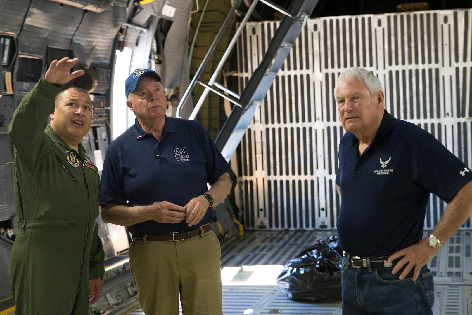 Master Sgt. Dave Delgado, a 356th Airlift Squadron load master, explains the different load configurations of a C-5M Super Galaxy aircraft to Jon Walker (left), Family Motor Coach Association  senior vice president, and Charlie Adcock FMCA president, Feb. 21, 2017 at Joint Base San Antonio-Lackland, Texas. Adock, a retired Air Force load master, stopped by the 433rd Airlift Wing to view the unit's new C-5M Super Galaxy which arrived in June 2016.  (U.S.  Air Force photo by Benjamin Faske)