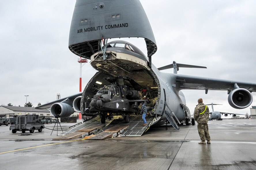An Army AH-64 Apache helicopter is unloaded from an Air Mobility Command C-5M Super Galaxy at Ramstein Air Base, Germany, Feb. 22, 2017, in support of Operation Atlantic Resolve. The four Apache helicopters that arrived are part of a larger contingent of helicopters and personnel supporting OAR, a U.S. commitment to maintaining peace and stability in the European region. (U.S. Air Force photo/Staff Sgt. Timothy Moore)