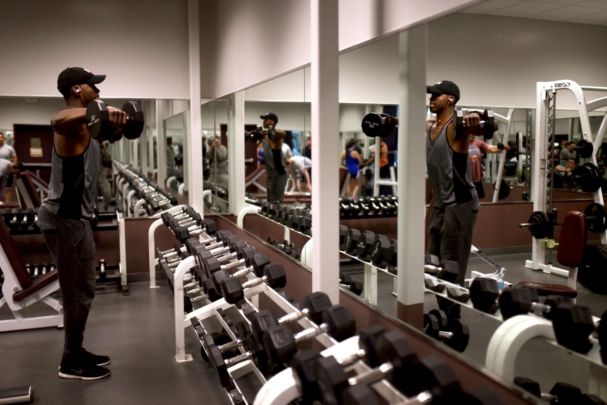 PETERSON AIR FORCE BASE, Colo. – Senior Airman Garth Salmon, 21st Force Support Squadron fitness specialist, works out with free weights at the Fitness Center on Peterson Air Force Base, Colo., Feb. 15, 2017. As a skinny child, Salmon grew up in Jamaica where he endured years of bullying and fights. (U.S. Air Force photo by Airman 1st Class Dennis Hoffman)