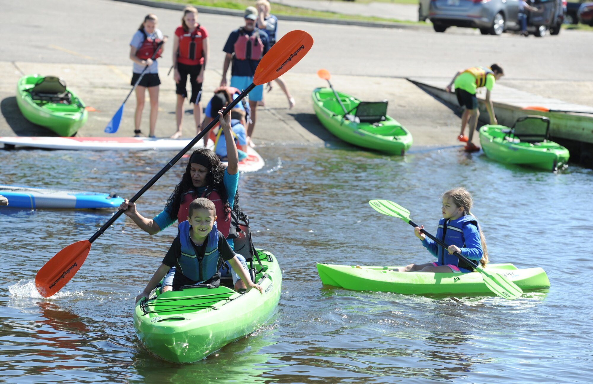 Keesler personnel and family members steer their kayaks through the Keesler Marina during the Polar Bear Regatta at Marina Park Feb. 18, 2017, on Keesler Air Force Base, Miss. Keesler Outdoor Recreation sponsored the event, providing kayaks and paddle boards for use. (U.S. Air Force photo by Kemberly Groue)