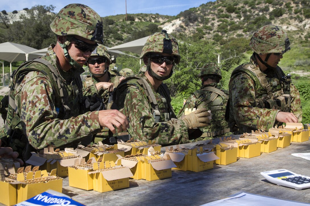 Japanese soldiers draw ammunition before participating in a live-fire event with U.S. Marines as part of Exercise Iron Fist at Marine Corps Base Camp Pendleton, Calif., Feb. 13, 2017. During the event, Japanese soldiers moved as a squad while facing simulated enemy forces. Iron Fist is an annual, bilateral training exercise where U.S. and Japanese service members train together and share techniques, tactics and procedures to improve their combined operational capabilities. Marine Corps photo by Lance Cpl. Tyler Byther