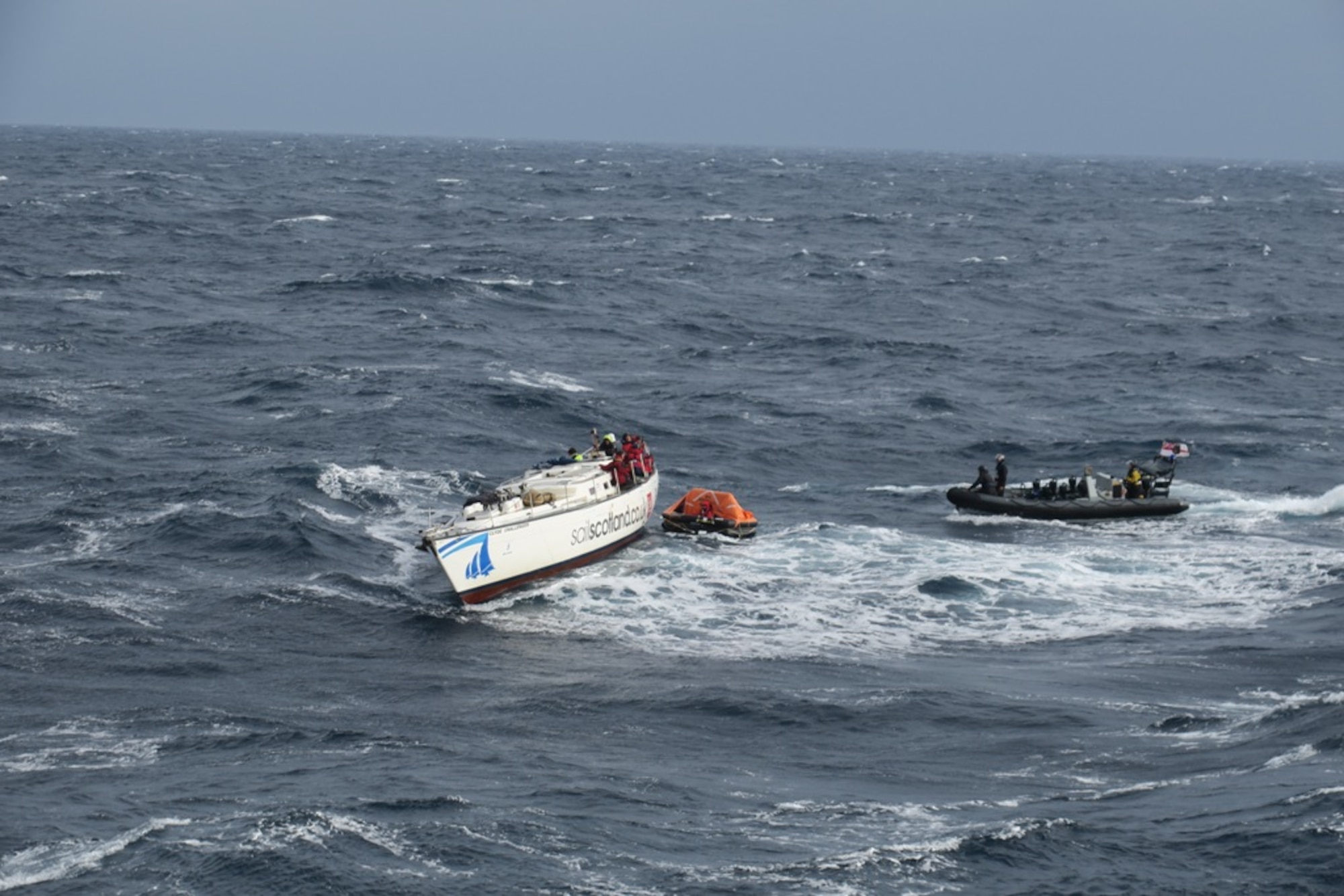 The HMS Dragon, a Royal Navy warship, rescues 14 stricken sailors from damaged British racing yacht Feb. 11, 2017, on the Atlantic Ocean. HMS Dragon was diverted 500 miles away from a routine tasking to provide life-saving assistance to the crew of the 60ft Clyde Challenger racing yacht. (Courtesy photo by Royal Navy)