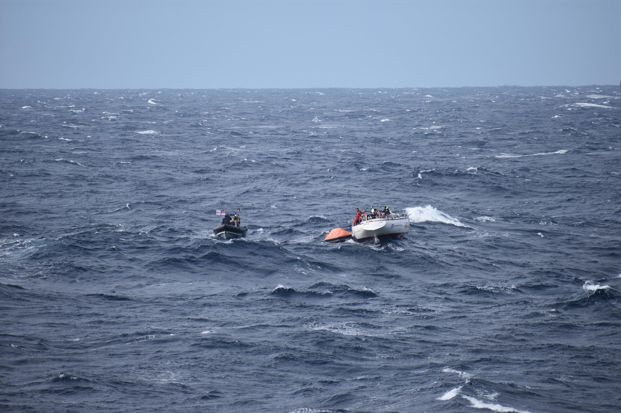 The HMS Dragon, a Royal Navy warship, rescues 14 stricken sailors from damaged British racing yacht Feb. 11, 2017, on the Atlantic Ocean. HMS Dragon was diverted 500 miles away from a routine tasking to provide life-saving assistance to the crew of the 60ft Clyde Challenger racing yacht. (Courtesy photo by Royal Navy)
