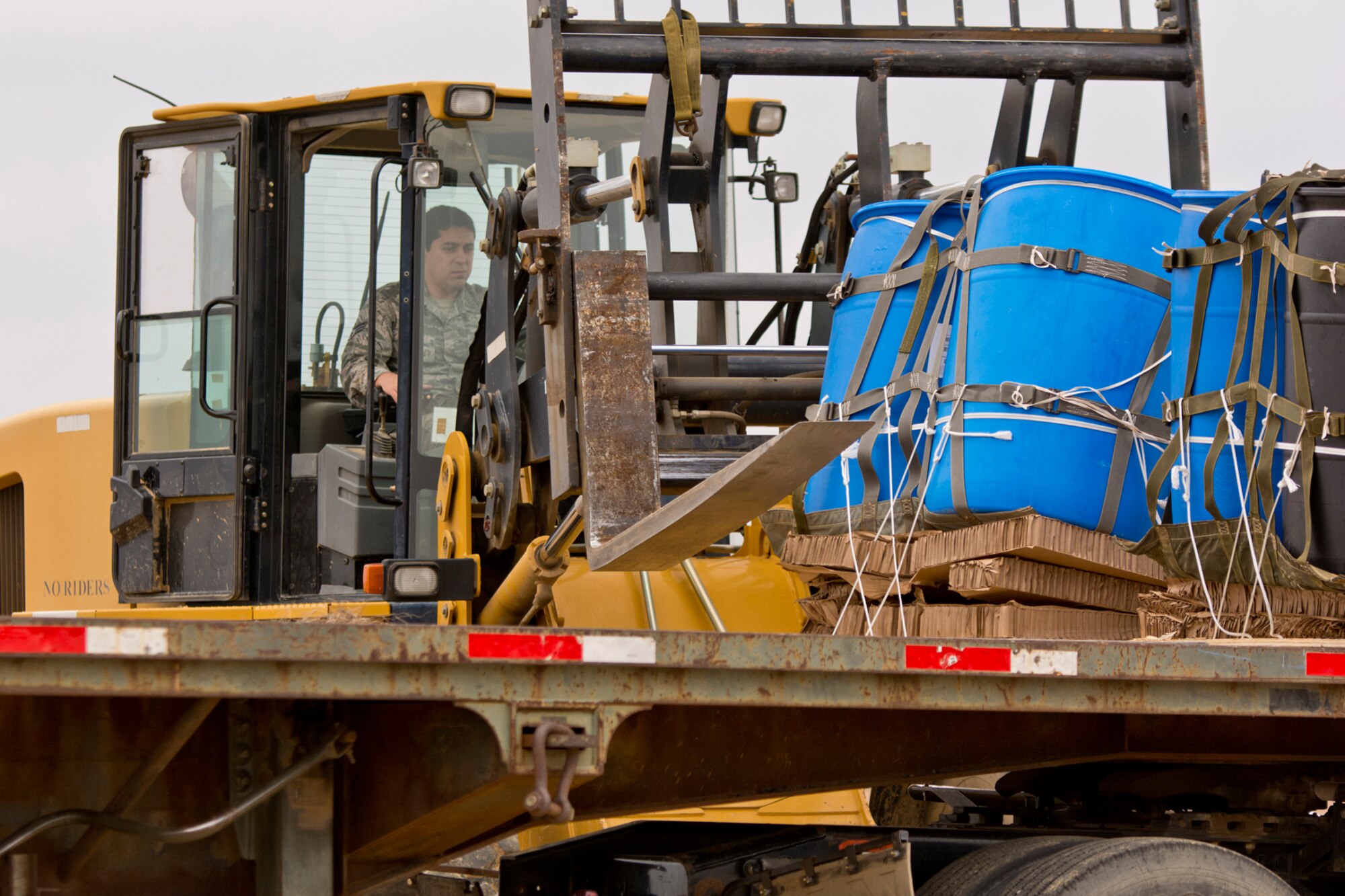 Senior Airman Alberto Ocampo, air transportation, 19th Logistics Readiness Squadron, uses a 10K All Terrain Forklift to load a water barrel container delivery system (CDS) onto a tractor trailer at the Blackjack Drop Zone Feb. 11, 2017, near Beebe, Ark. Airmen assigned to the 19th LRS recovered eight airdropped CDSs from the drop zone for return to Little Rock Air Force Base. (U.S. Air Force photo by Master Sgt. Jeff Walston/Released)