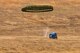 A water barrel container delivery system (CDS) bundle air dropped from a C-130J Super Hercules hits the ground at the Blackjack Drop Zone Feb. 11, 2017, near Beebe, Ark. The water barrel CDS is preferred to the steel cage load because less man power is needed for reconstitution of the CDS, and the cost savings to replace or repair the bundle. (U.S. Air Force photo by Master Sgt. Jeff Walston/Released)