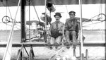 Photographer James Hare (left) sits aboard the new 1910 Wright “B” aircraft purchased by R.F. Collier, owner of Collier’s magazine, who lent the U.S. Army the airplane in March 1911 after the original 1909  Wright Flyer, Signal Corps No. 1 was retired. The Collier plane, together with a Wright factory pilot, Phillip Parmalee (right), arrived in San Antonio in February 1911, and Lt. Benjamin Foulois began to learn to fly the newer type aircraft. During the next several weeks, these two men demonstrated the advantages to be derived from using the airplane for photographic reconnaissance as well as courier duties between military units.