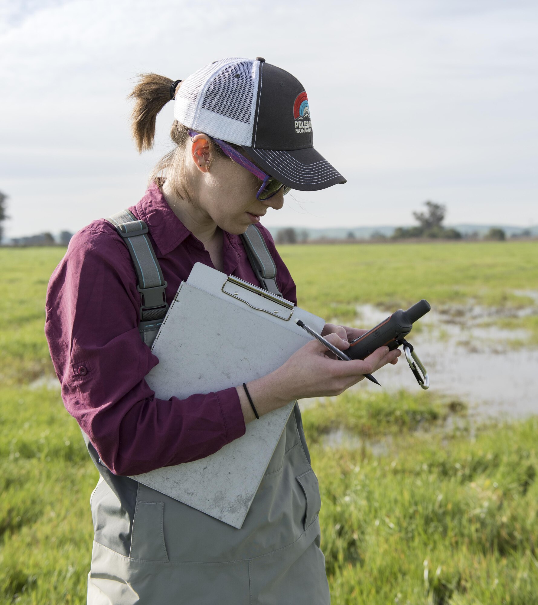 Brett Addis, a Ph.D candidate at the University of Montana, records data while obtaining samples from a vernal pond Feb 13, 2017 at Travis Air Force Base, Calif. Addis, part of a two-person team, is the field coordinator for a “habitat quality assessment” project to determine if Travis has a viable environment for the western spadefoot toad. The assessment includes recording data for vegetation type, soil friability and a visual check for mammal burrows and WST predators. The team will also collect DNA samples from several ephemeral vernal pools through a filter that will go back to a genetics lab to determine if any DNA from the WST is floating around the pool, indicating the toads have been there.  (U.S. Air Force photo/ Heide Couch)