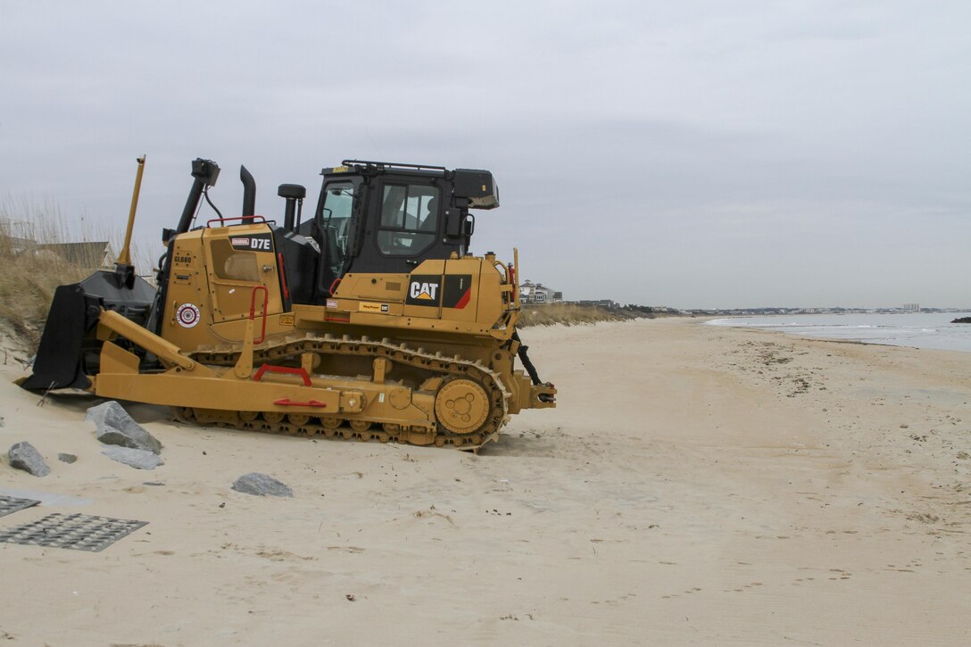 NORFOLK, VA – Heavy equipment is staged along the beach in Norfolk, Virginia’s East Ocean View neighborhood. Contractors will use the equipment to move dredged up sand on the beach to create a 60 foot wide beach berm that slopes to 5 feet above mean low water. Engineers’ designed the beach to absorb the wave energy, protecting critical infrastructure during coastal storms. (U.S. Army photo/Patrick Bloodgood)