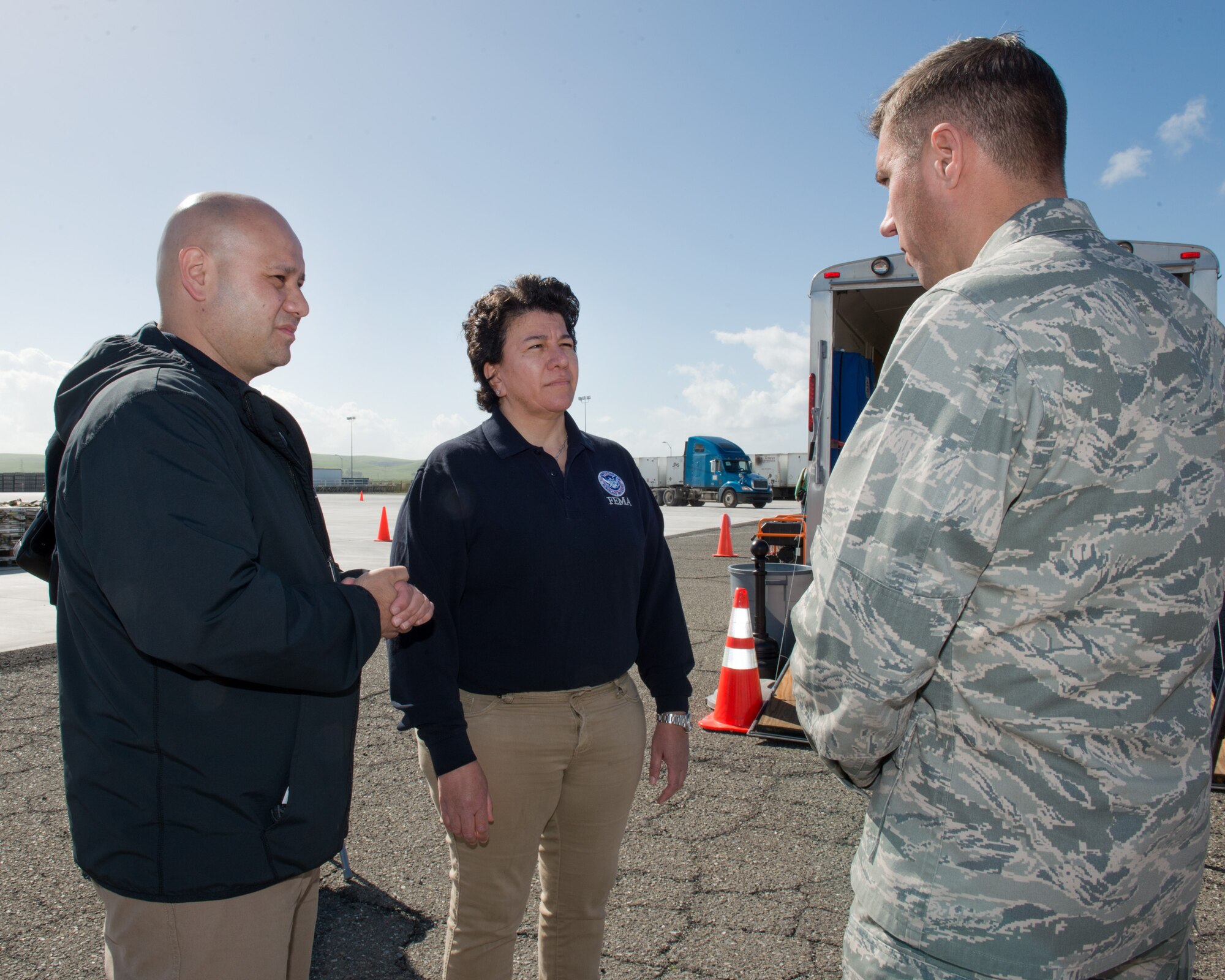 U.S. Air Force Col. John Klein, 60th Air Mobility Wing commander, talks with representatives from the Federal Emergency Management Agency at Travis Air Force Base, Calif., Feb. 16, 2017. Travis AFB is acting as a staging area for FEMA personnel, providing space for necessary equipment and supplies in case of the Oroville auxiliary spillway failure. (U.S. Air Force photo/Louis Briscese)